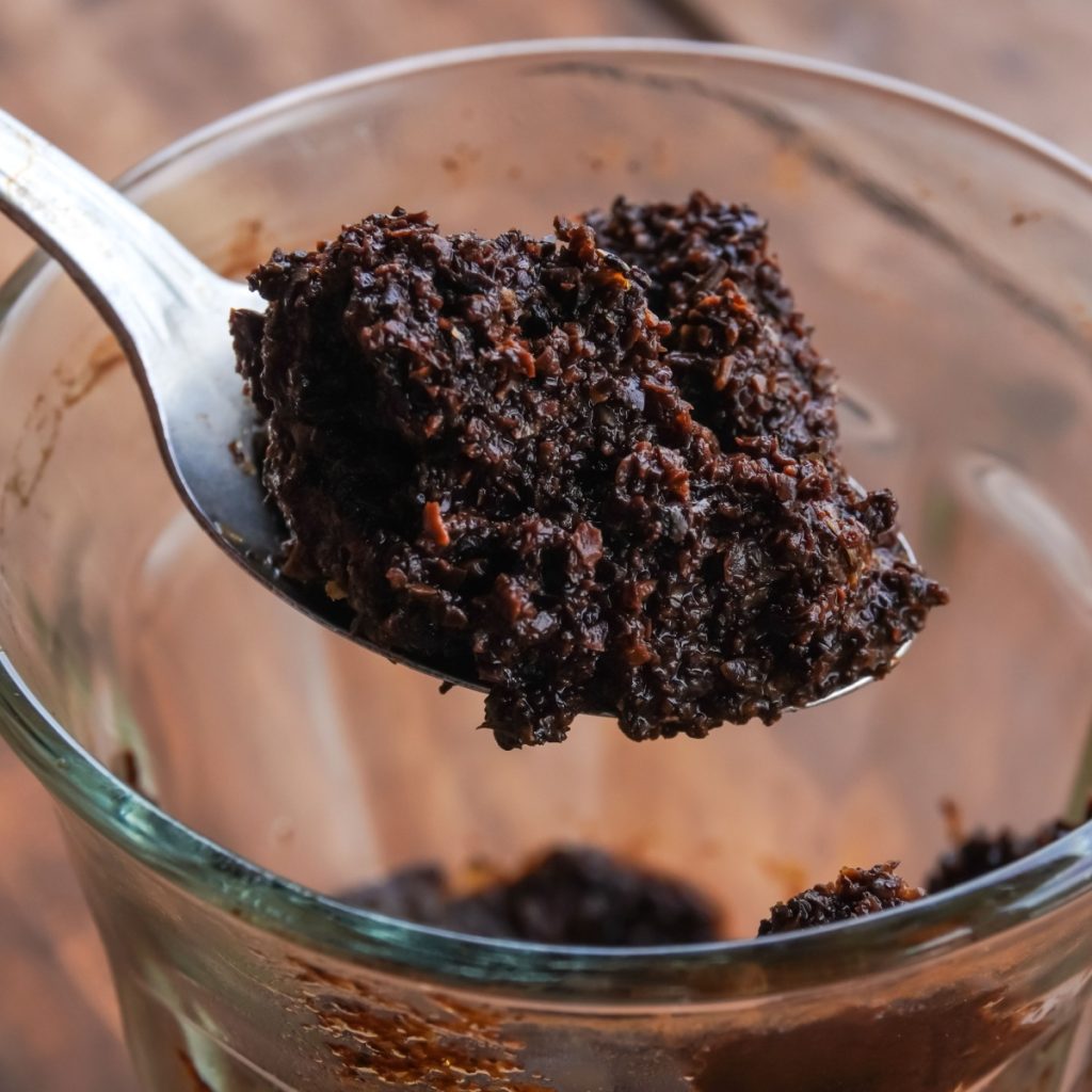 A spoonful of spent coffee grounds